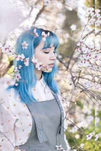 Full length of woman with cherry blossom