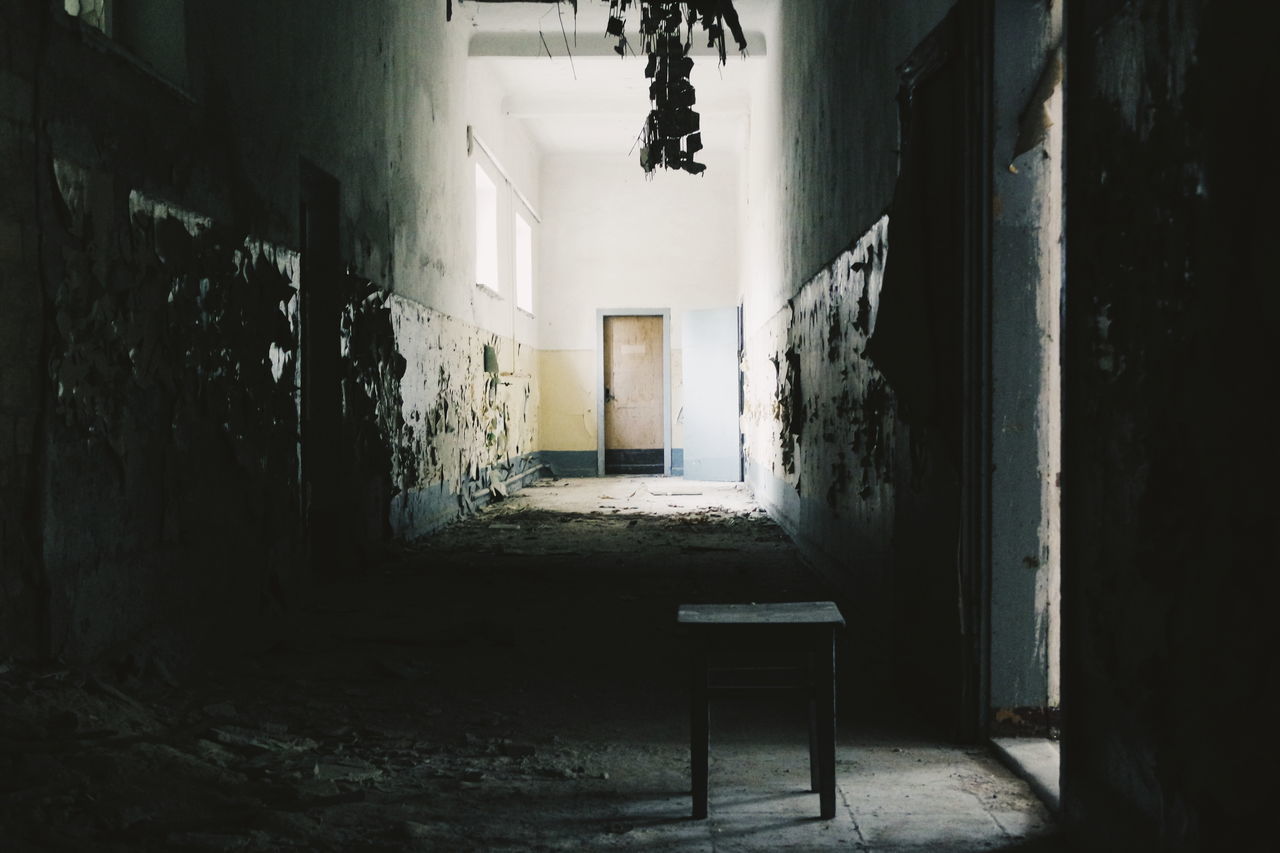 EMPTY CHAIRS IN ABANDONED ROOM