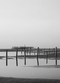 Pier over sea against clear sky