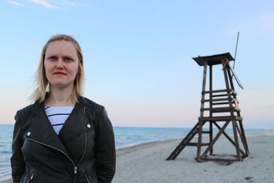 Portrait of young woman standing on beach