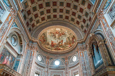 Low angle view of ornate ceiling in temple