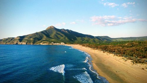 Scenic view of sea and mountains against sky