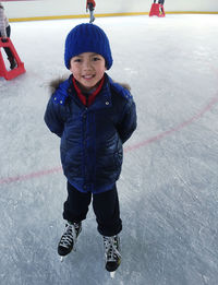 Full length of cute boy in snow