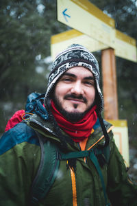 Portrait of young man standing in snow