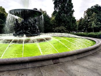 Fountain in park against sky