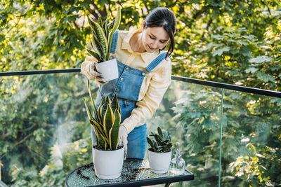 Portrait of boy standing against trees