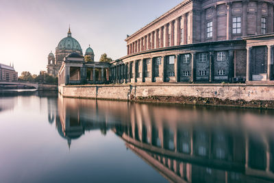 Low angle view of river with buildings in background