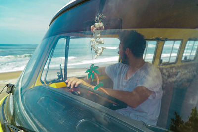 Man driving van at beach