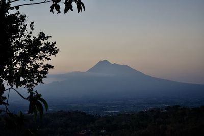 Scenic view of mountains against sky at sunset