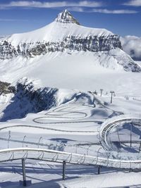 Scenic view of snow covered mountains against sky