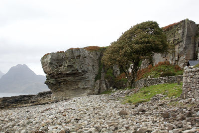 Rock formations on landscape against sky