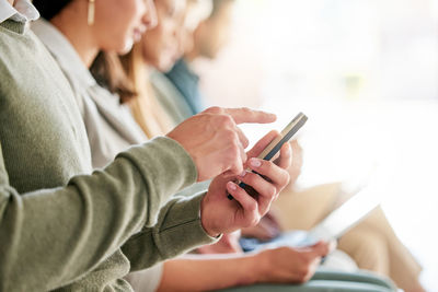 Midsection of woman using mobile phone