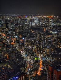 High angle view of illuminated city buildings at night