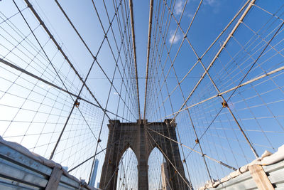 Low angle view of brooklyn bridge against blue sky