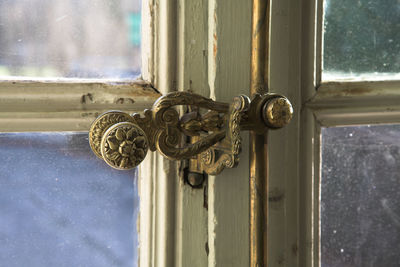 Close up on a glass window door and doorknob, natural light