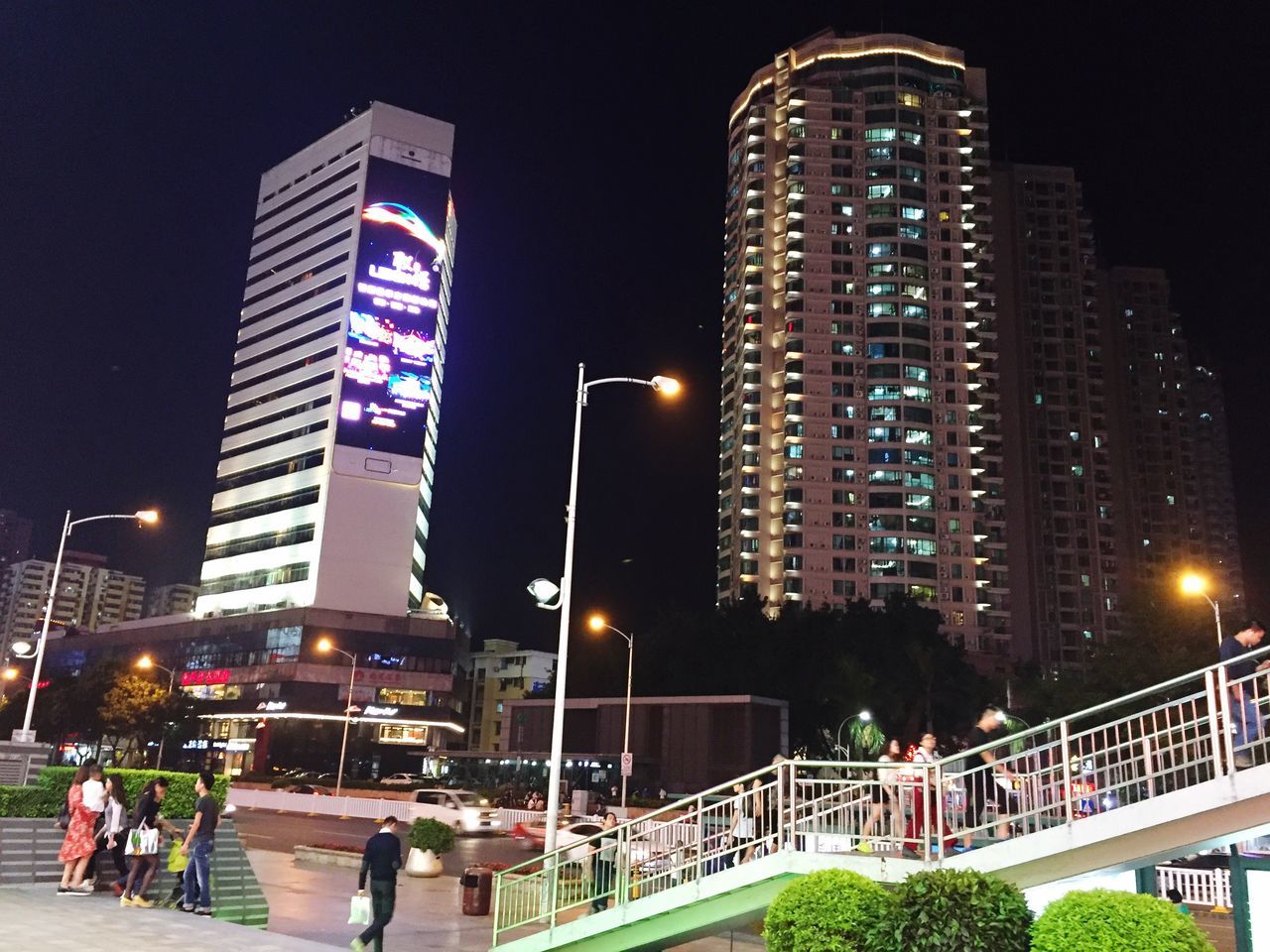 night, illuminated, architecture, city, skyscraper, building exterior, built structure, lighting equipment, modern, sky, motion, outdoors, urban skyline, people, adults only, adult