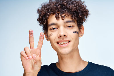 Portrait of smiling man against blue background