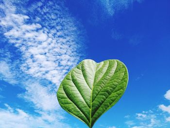 Low angle view of heart shape against blue sky