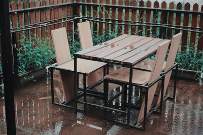 High angle view of empty chairs on table in rainy season
