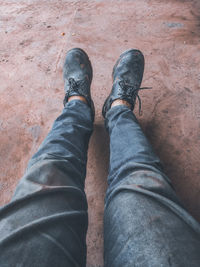 Low section of man wearing shoes standing outdoors