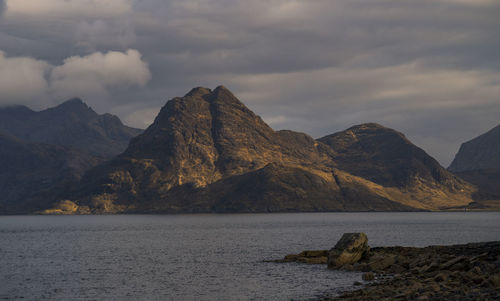 Scenic view of sea and mountains against sky