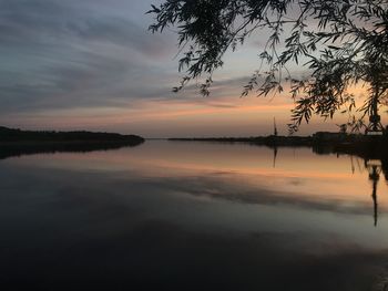 Scenic view of river against sky during sunset