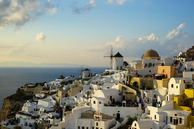 Townscape by sea against sky