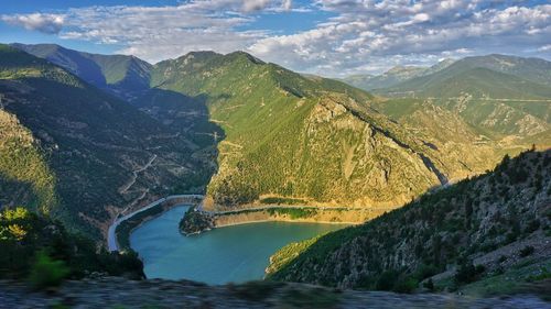 Scenic view of river amidst mountains against sky