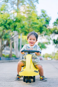 Cute boy sitting in toy