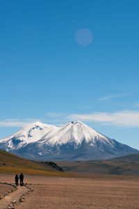 Scenic view of snowcapped mountains against clear blue sky