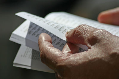 Cropped hands of person holding book