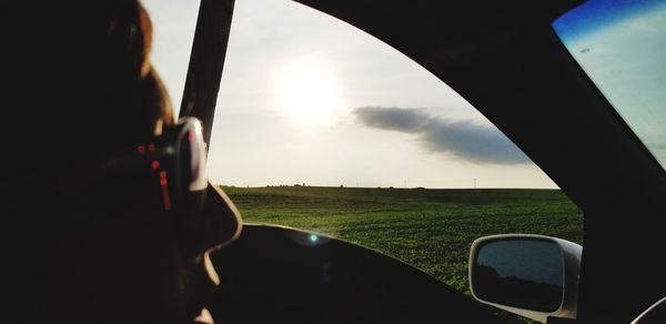 Scenic view of field seen through car window