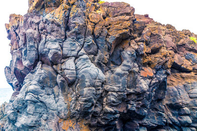 Low angle view of rock formation against sky