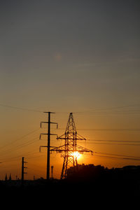 Sunset scene with shadow of electricity poles and houses