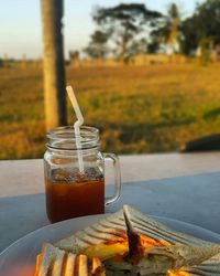 Close-up of sandwich served with drink on table