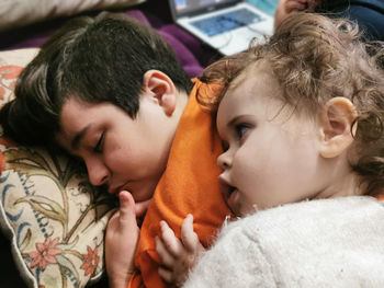 Portrait of mother and daughter relaxing on bed