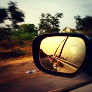 Reflection of sky in side-view mirror