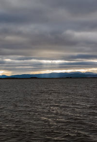 Scenic view of sea against storm clouds