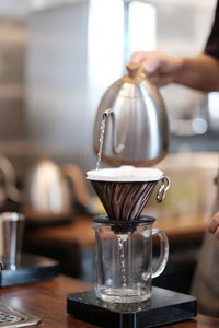 Midsection of coffee cup in kitchen at home