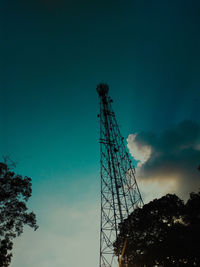 Low angle view of communications tower against blue sky