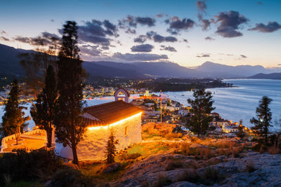 High angle view of illuminated buildings against sky at sunset