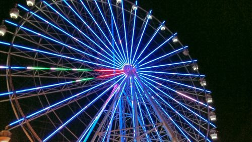 Low angle view of ferris wheel against sky at night