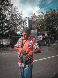 Young man standing on road in city