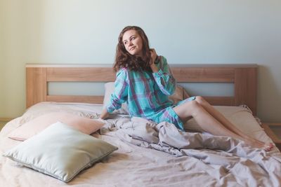 Portrait of young woman sitting on sofa