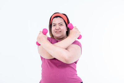 Woman with pink hair against white background