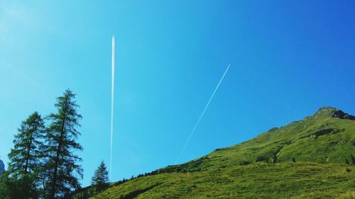 Scenic view of mountains against blue sky