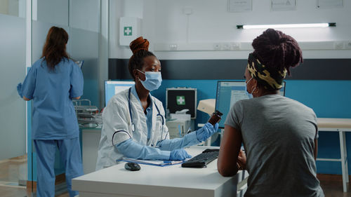 Doctor having discussion with patient in clinic