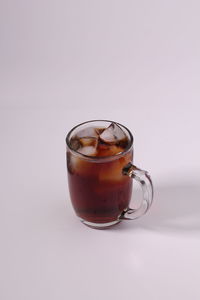 Close-up of beer glass against white background