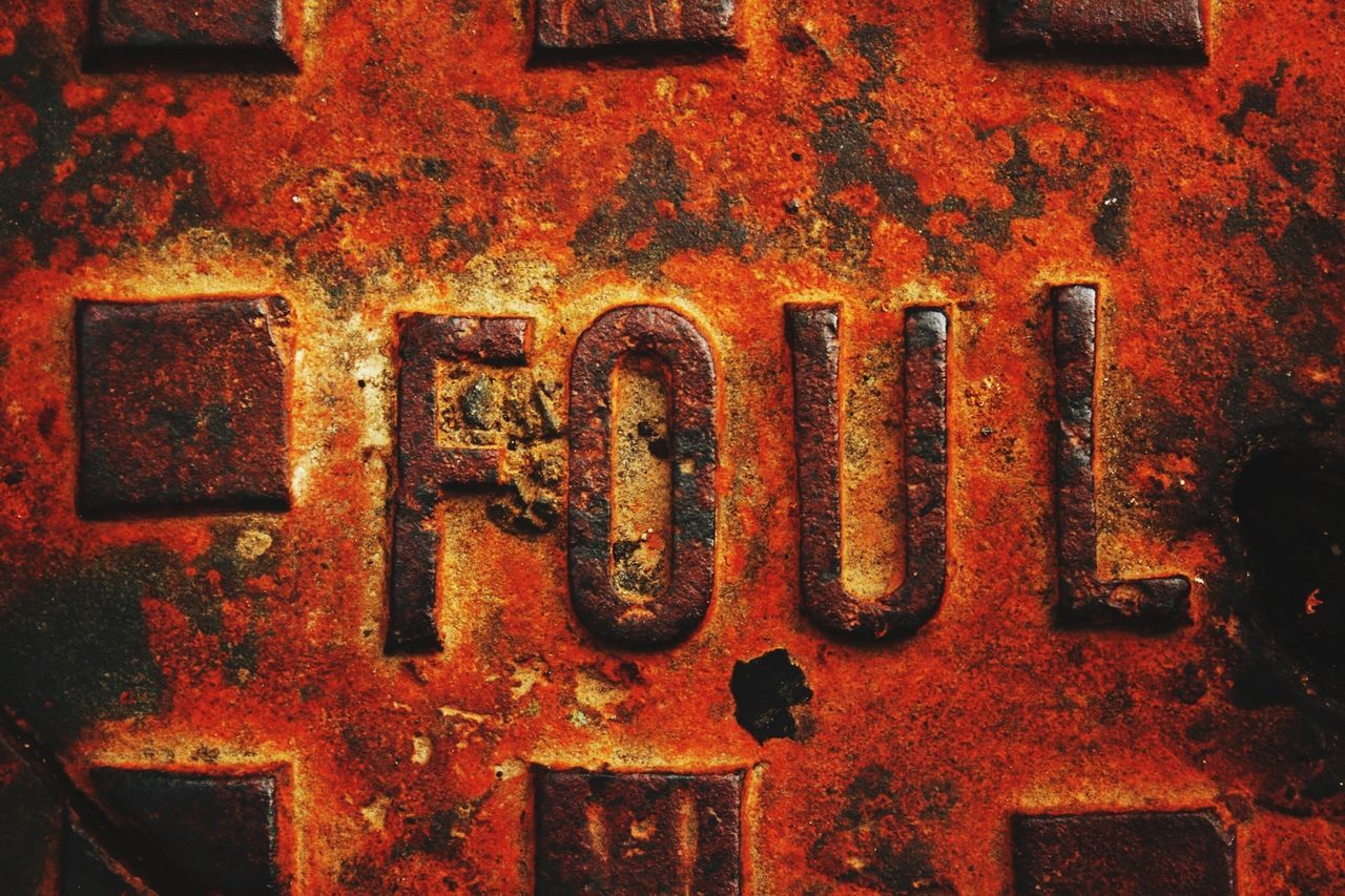 red, full frame, close-up, communication, architecture, built structure, text, backgrounds, metal, rusty, western script, wall - building feature, building exterior, orange color, no people, old, weathered, metallic, outdoors, brick wall