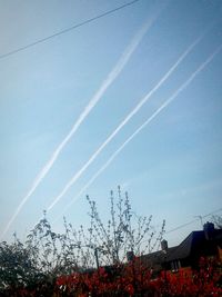 Low angle view of vapor trails against sky